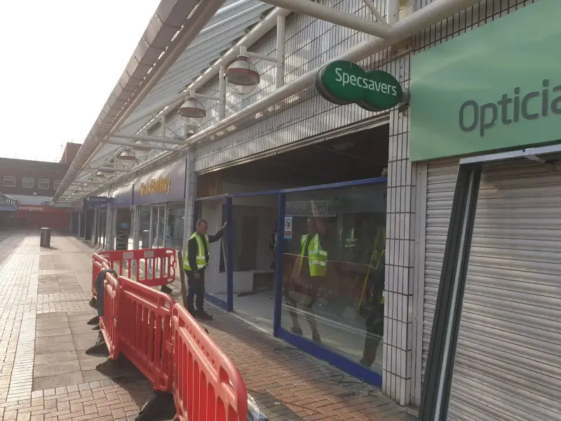 Shop front at Birkenhead Specsavers being taken out to the new expansion unit: Swipe To View More Images
